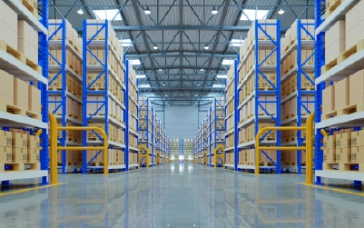 Large commercial warehouse with organized pallet racking and industrial shelving