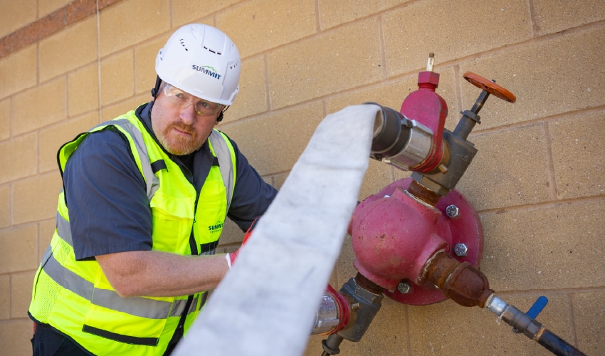 Worker operating fire safety equipment.
