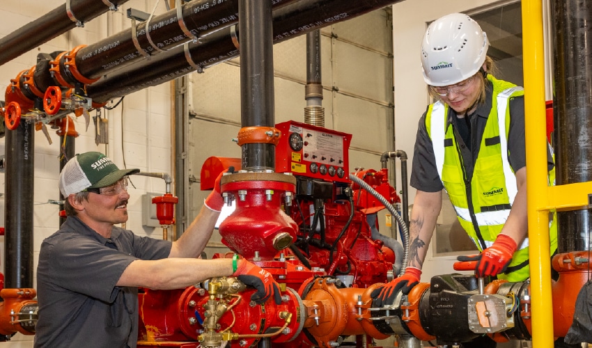 Two industrial technicians inspecting industrial fire suppression equipment