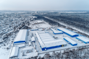 Snow-covered warehouse complex aerial view