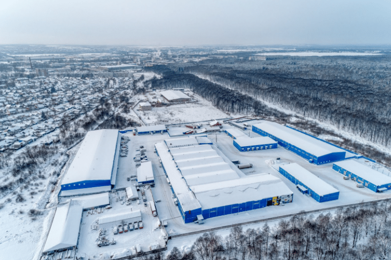 Snow-covered warehouse complex aerial view