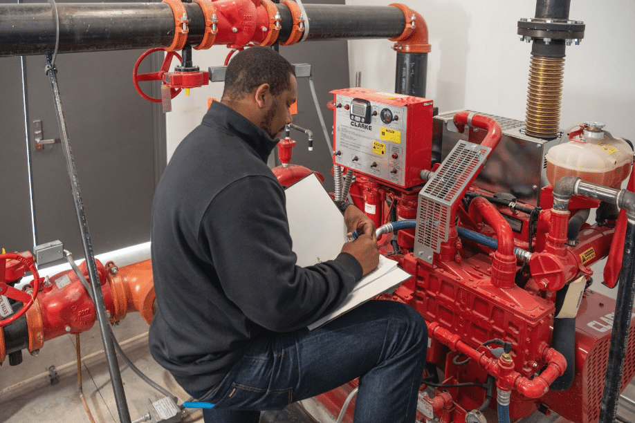 Summit Fire National Accounts employee completing an inspection of a fire pump